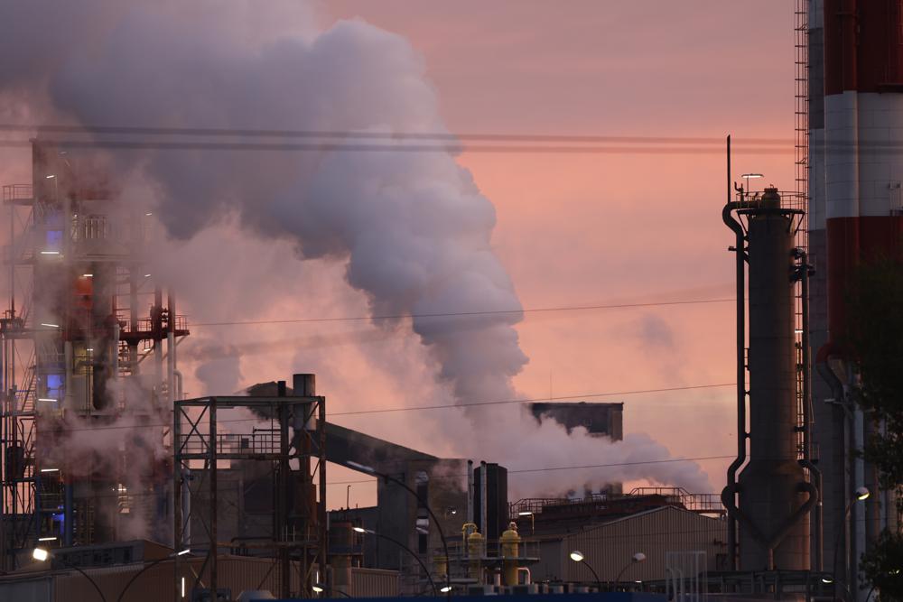 Macron urges France’s big polluters to cut emissions by half