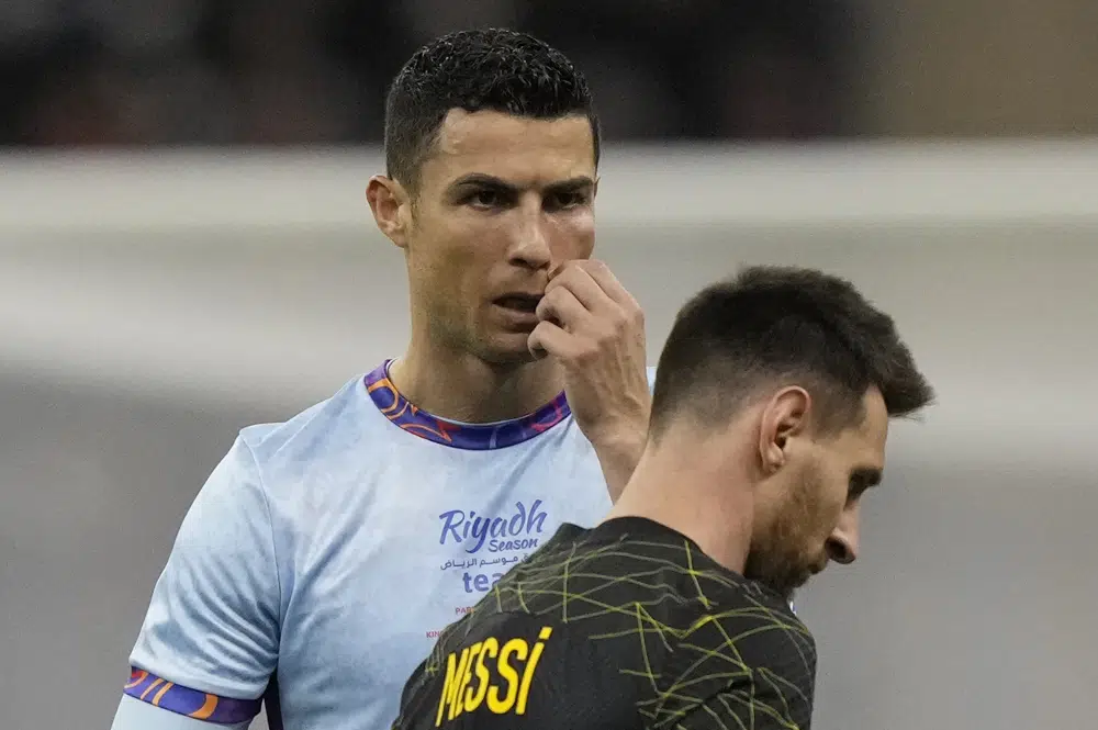Bruised Ronaldo scores twice to edge showdown with Messi