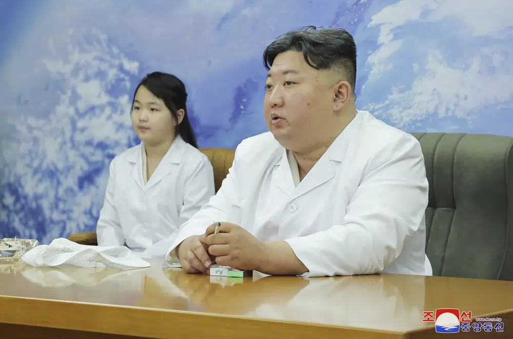 Kim Jong Un examines a military spy satellite