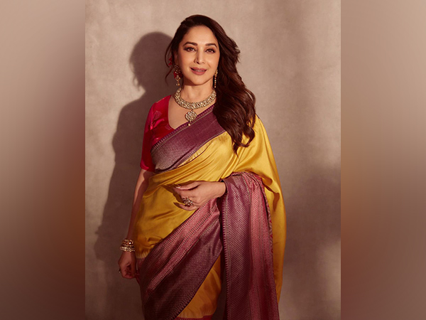 Madhuri Dixit looks gorgeous in a yellow saree