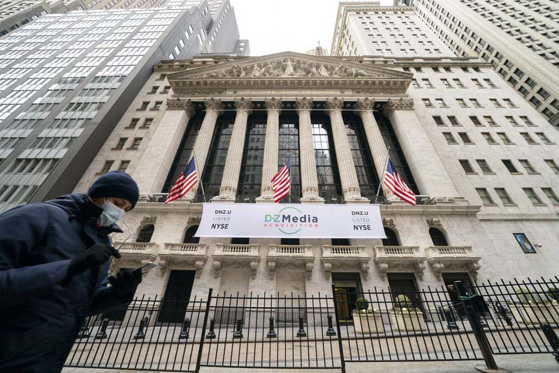 Global shares mostly lower as investors wary over stimulus