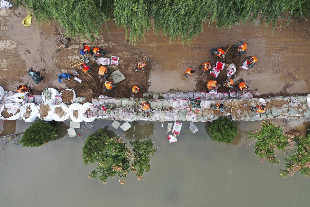 Flooding sends bus into river in China