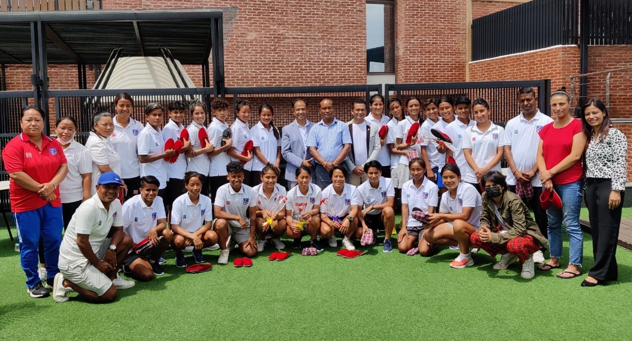 Female footballers celebrate Teej in closed training